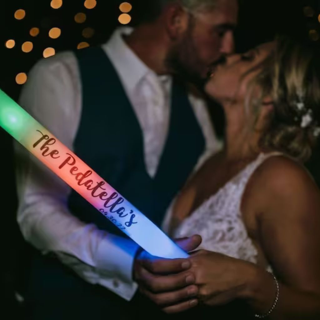 a man and a woman kissing in front of a light saber