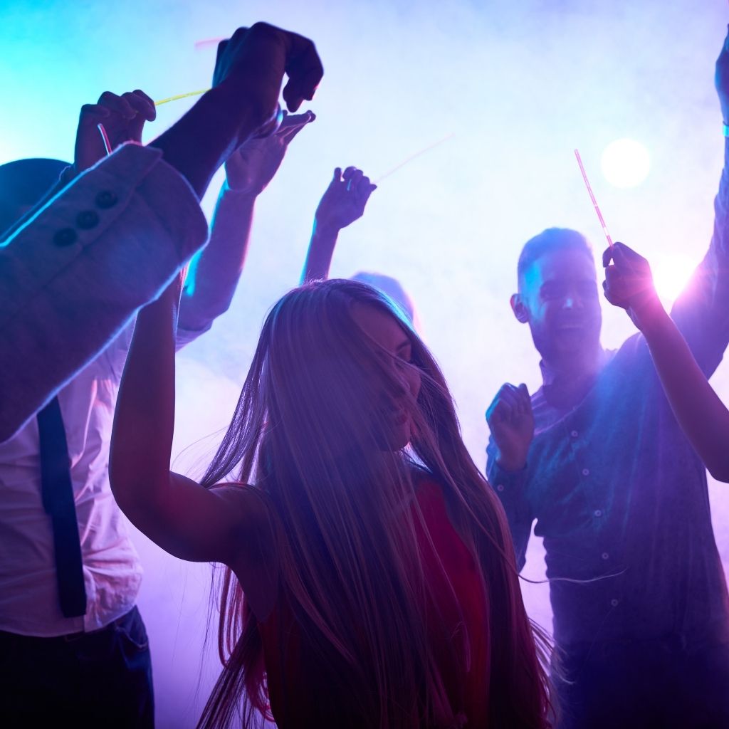 a group of people dancing at a party