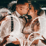 a bride and groom kissing while surrounded by sparkle