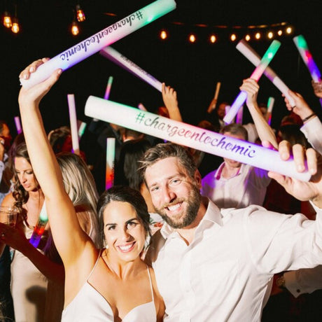 a man and a woman are holding up some lights