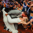 a bride and groom kissing on the dance floor